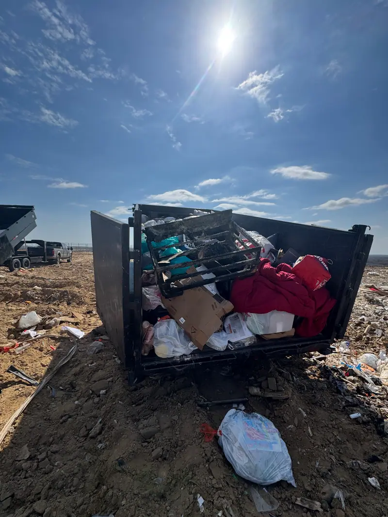 Trailer unloading at the landfill with a second truck waiting behind