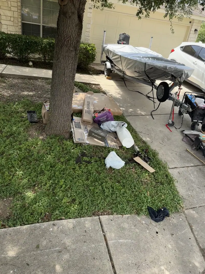 Household items, a toolbox and broken furniture lined up on a New Braunfels driveway for haul off
